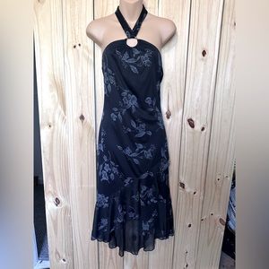 Black fitted halter dress with o-ring neckline and ruffled skirt